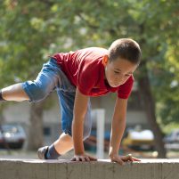 Parkour jump over wall 2 Young boy doing parkour exercise jumping over wall